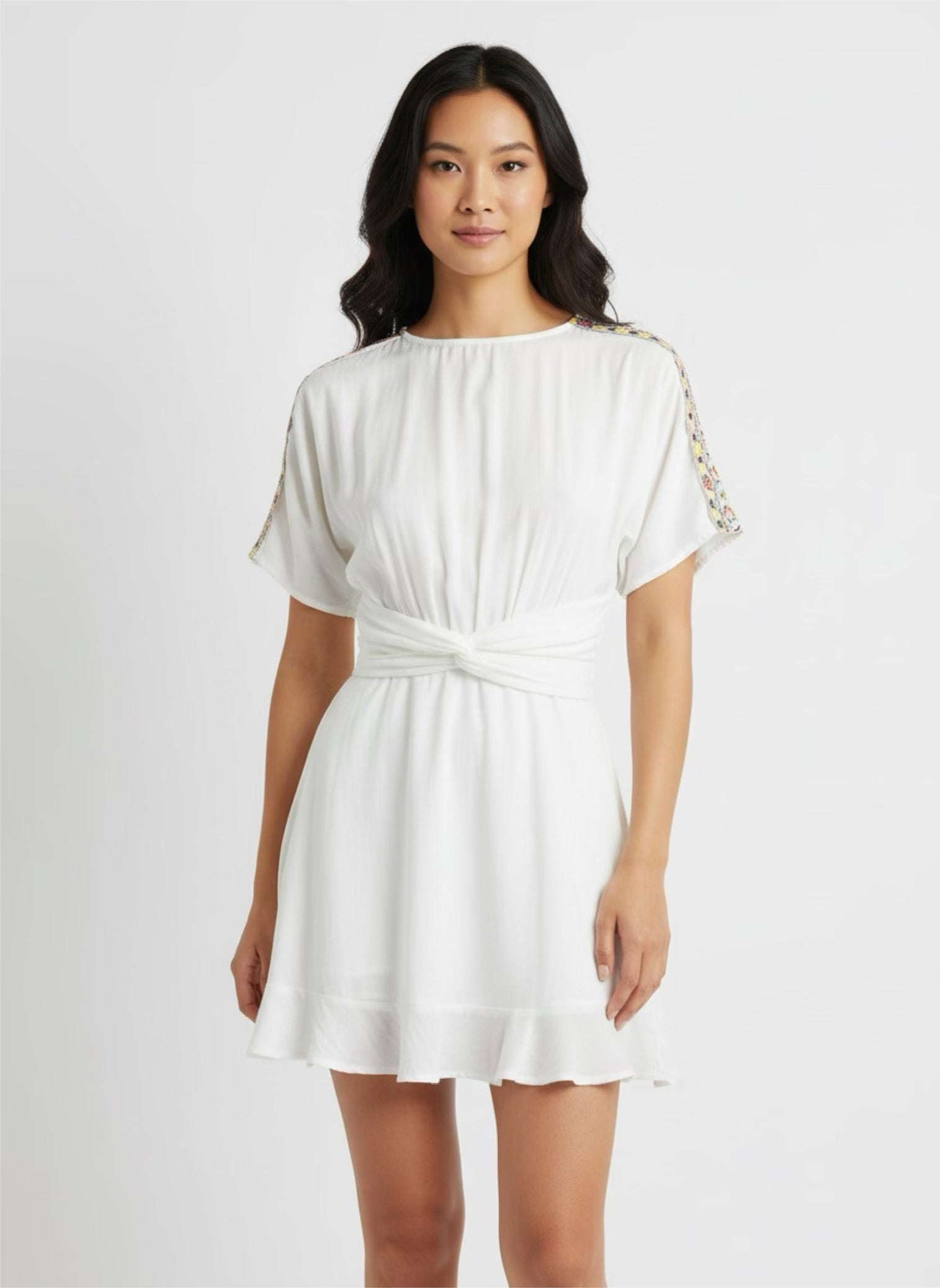 White skater dress with gold and colored yoke on the arms and open back