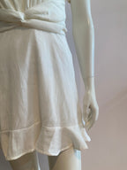 White skater dress with gold and colored yoke on the arms and open back