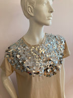 Beige top with large silver sequin on the front