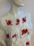 White top with ruffle and red embroidery
